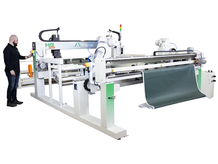 Miller Weldmaster HG50 hot-air welding a banner hem, supplied by Magnum India